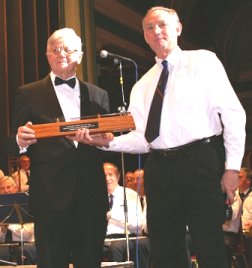 Paul Neville receives a silver baton from the members of the All Stars Band