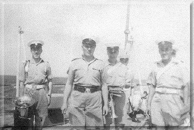 Some of the depleted Euryalus Band on q.deck. L to r. Harold Beatty, 'Tanky Boyes, Chippy Carpenter,  and  B.Cpl.?? (Trombone)