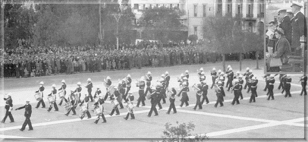 Massed Bands of the 1st Cruiser Squadron 'Beating Retreat' in Constitution Square, Athens Jan. 1949  before King Paul and Queen Frederica (inset). Drum Major Bd.Sgt. Boyes. Flt. Cmd.B'master. 'Bill' Fitzgerald.