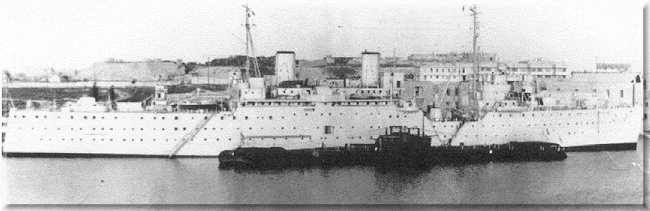 HMS Forth and a couple of her brood of ducklings - T class submarines moored end to end, at her usual moorings alongside Manoel Island, Sliema Creek. Malta.