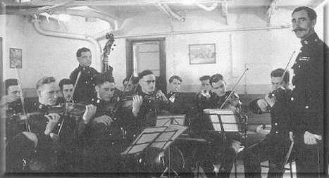 Forth Band practising in the canteen under the flamboyant baton of 'Joe' Dixon. Front Row. L to R. (Hands only) Ted Stigwood,  Taff Lewis, Taff Evans, Self, Ron DeLorey and Woodfield. Back row, 'Whacker' Paine, 'Rattler' Morgan, 'Knocker' Paine, Hedley Paxton, Jimmy Dowling, Alan Quarterly.