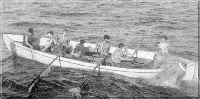Recovering the practice torpedo. KR's and A.I's stated that an Admiralty whaler could not sink. The Cheviot's whaler crew can be seen testing this theory after the torpedo had shattered its hull. Note the in-boat water-level!