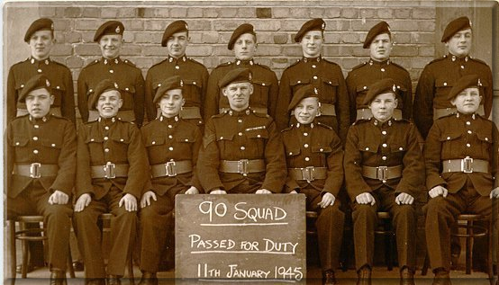 90 squad - 'After'  l to r (back row) Fattorini, Day, Taylor, Martin, Jackson, Rumming, Walton.  (Front row) Mayer, Hall, Oakley. C/Sgt Pook, Oakey, E. Smith, Wheatley.  (Flounders D. was in hospital for removal of his appendix.  One or two others were also missing from this photographic proof of our more or less successful transition to R.M. Band Boys.