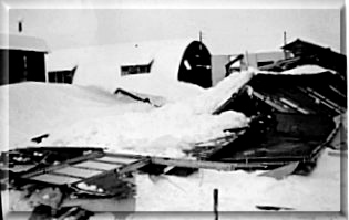Not all the pre-fabricated huts could withstand the heavy snows of a Burford winter.  Note thickness of the snow on the 'still standing' adjoining hut!