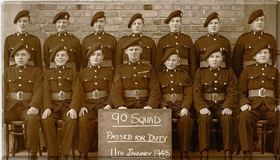 90 squad - 'After'  l to r (back row) Fattorini, Day, Taylor, Martin, Jackson, Rumming, Walton.  (Front row) Mayer, Hall, Oakley. C/Sgt Pook, Oakey, E. Smith, Wheatley.  (Flounders D. was in hospital for removal of his appendix.  One or two others were also missing from this photographic proof of our more or less successful transition to R.M. Band Boys.